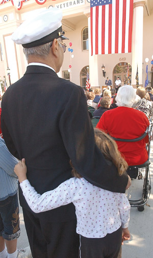 Arthur Rochelle embraces his 7-year-old granddaughter Madi
Ballesta during the closing ceremonies at the Veterans Day
celebration Tuesday morning.