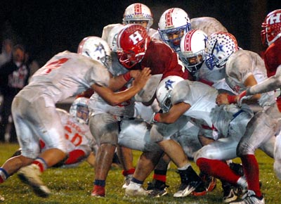 Nick Acosta drags seven defenders down field to pick up a
pivotal first down as the Balers wound down the clock in the fourth
quarter.