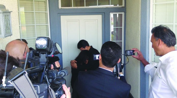 Police allege homicide suspect fired into car, now may be aided by others