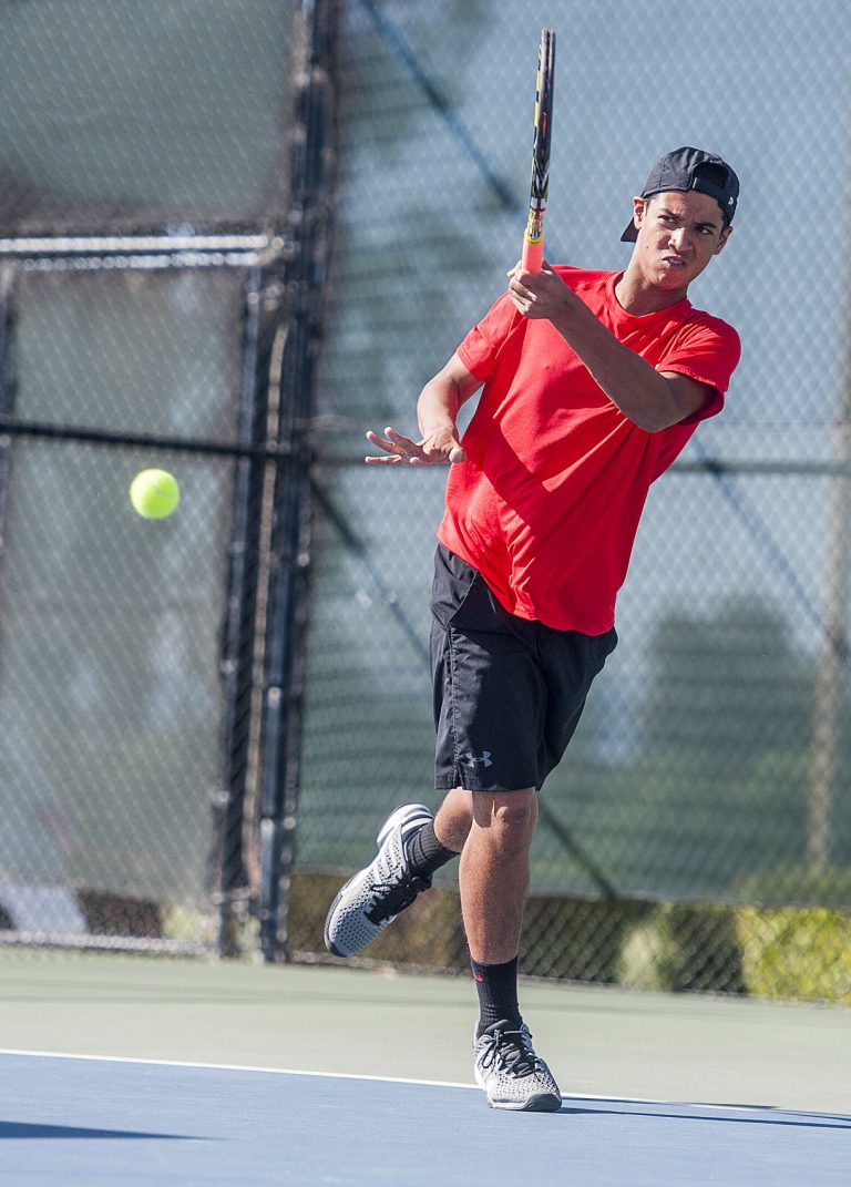 Balers having a racket