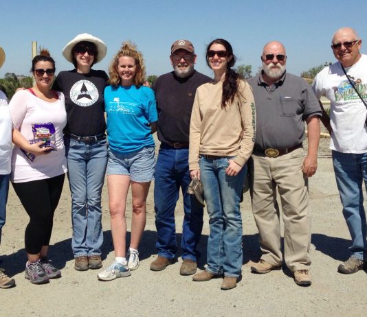 Students remove trash from riverbed before Earth Day