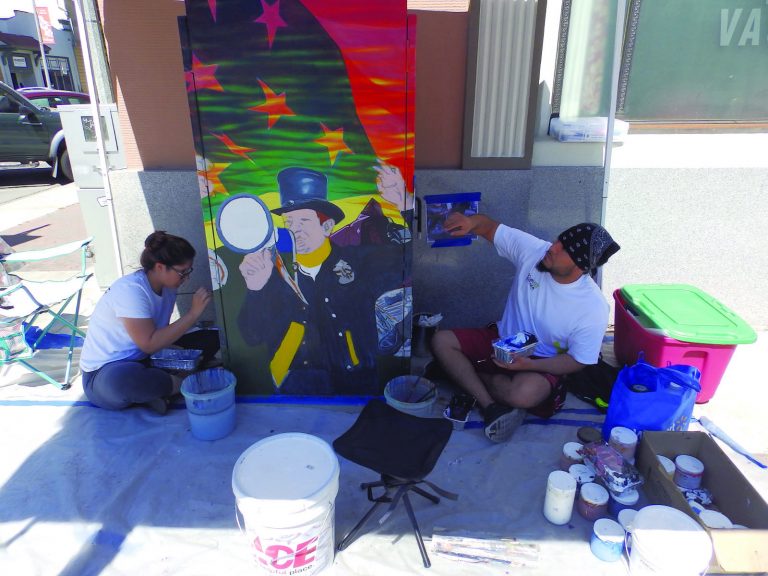 Artists put finishing touches on utility boxes