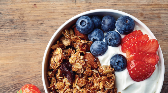 healthy bowl of full-fat yogurt with fruit and granola