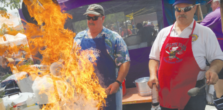 DELISH DISH John Vickory and Bruce Parker fire up the mushroom and shrimp scampi for the Gilroy Elks booth at the 36th annual Mushroom Mardi Gras. Photo Robert Eliason