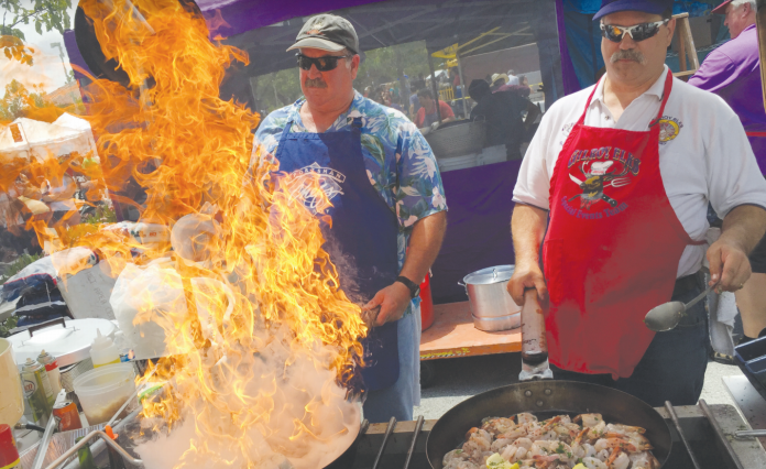 DELISH DISH John Vickory and Bruce Parker fire up the mushroom and shrimp scampi for the Gilroy Elks booth at the 36th annual Mushroom Mardi Gras. Photo Robert Eliason