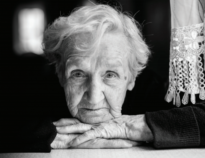 senior woman facing camera b/w photo