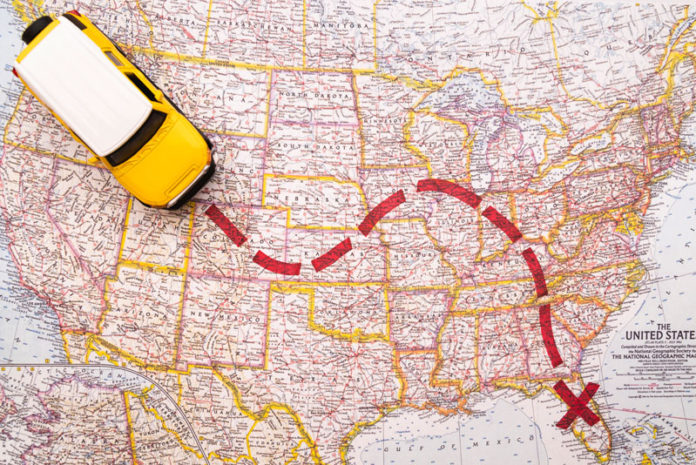 Miniature car following a trail on a map, emphasizing how flexible work arrangements influence moving patterns