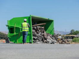 Truck pulling waste bin rolls over on Fairview Road
