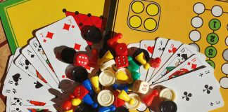 Various board games, game pieces, dices and playing cards