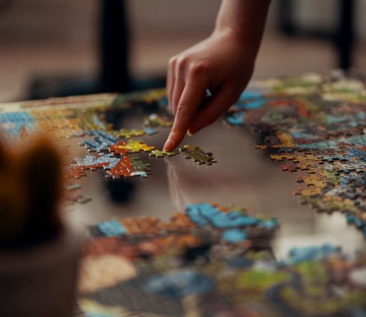Fun Activities in San Benito County, California Person holding jigsaw puzzle pieces